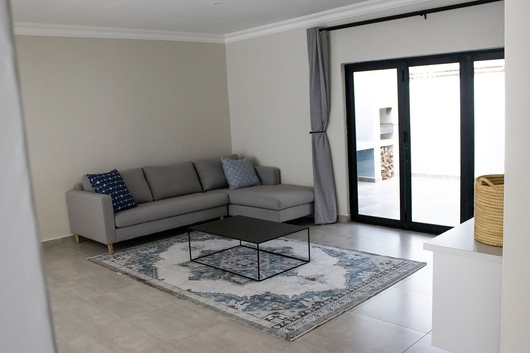 Lounge with grey sofa and glass doors