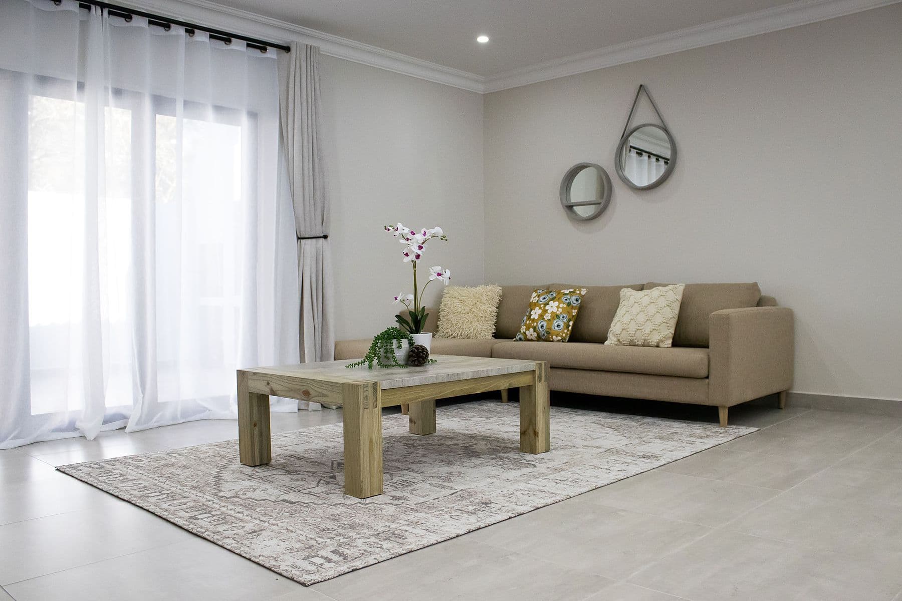Family unit: lounge with sofa, coffee table and orchid