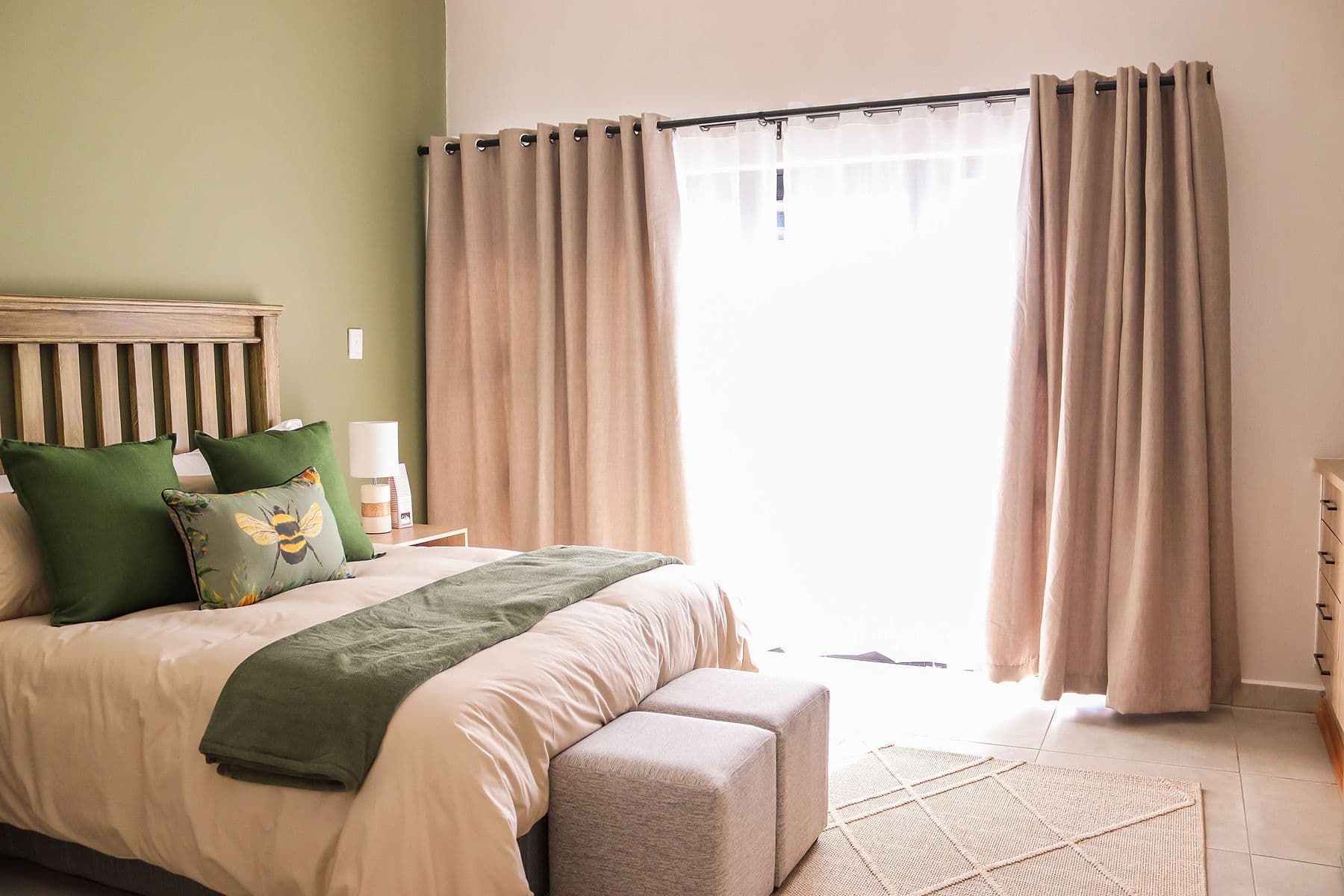 Sage Room: bed beside curtained window