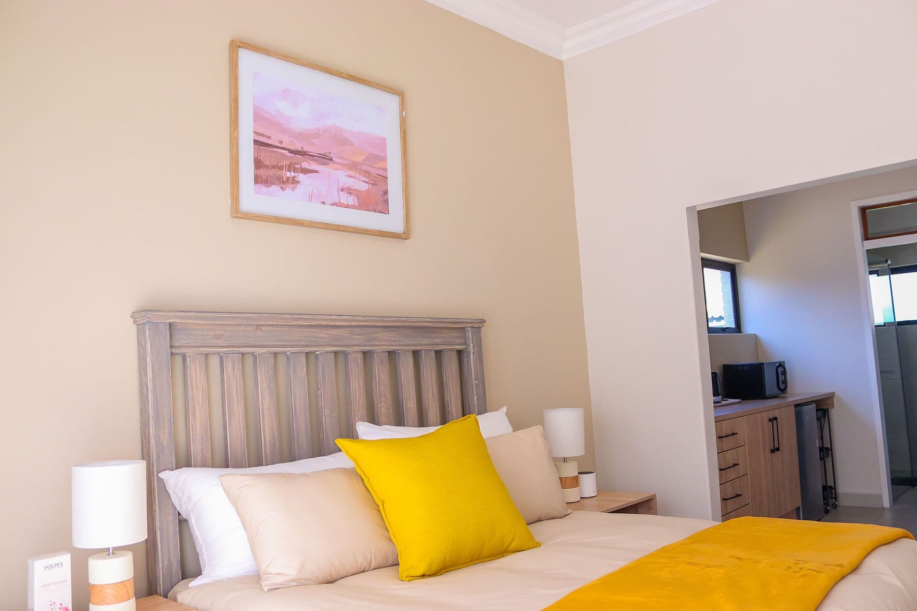 Saffron Room: bed with yellow cushion
