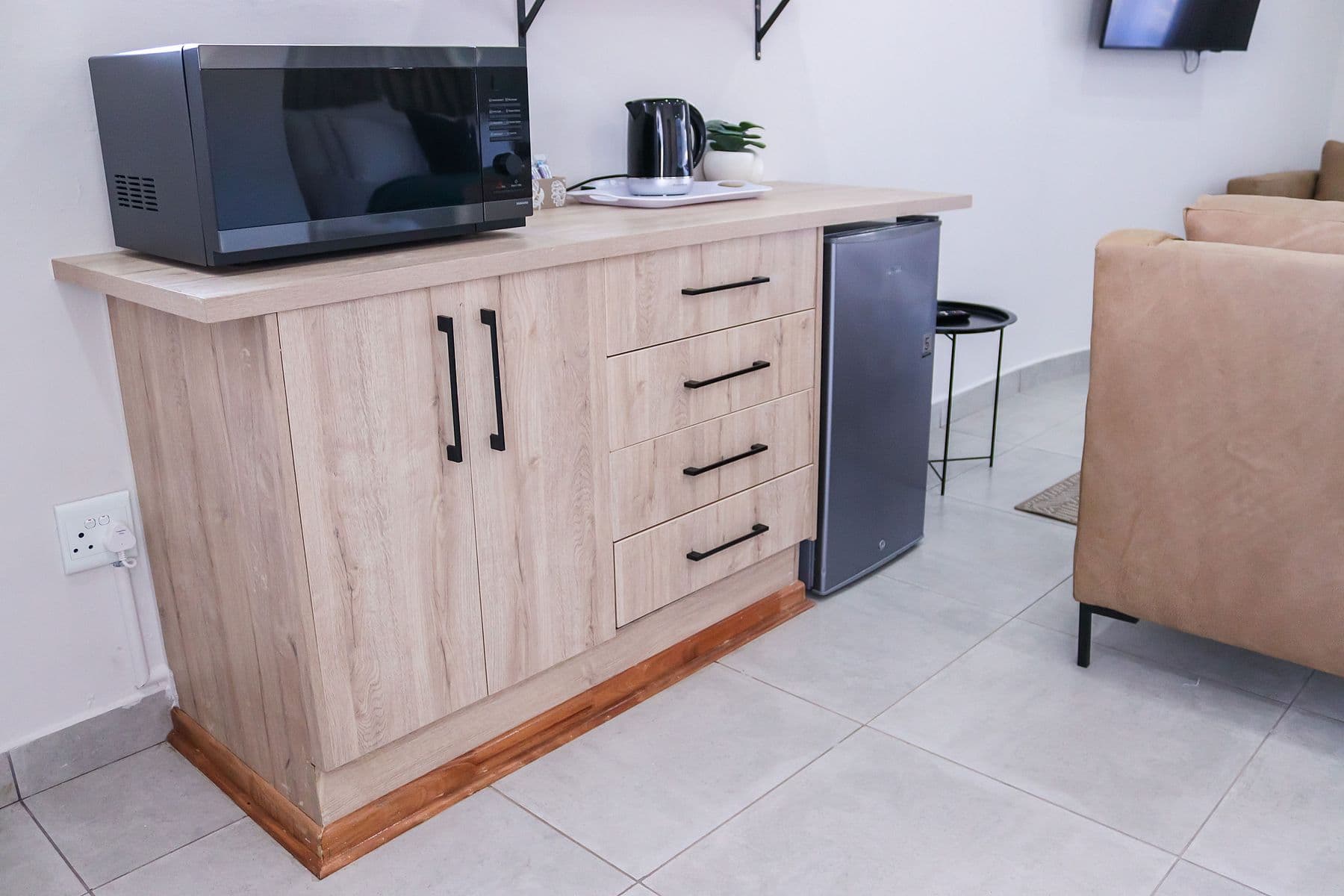 Teal Suite: kitchenette cabinet with microwave and kettle