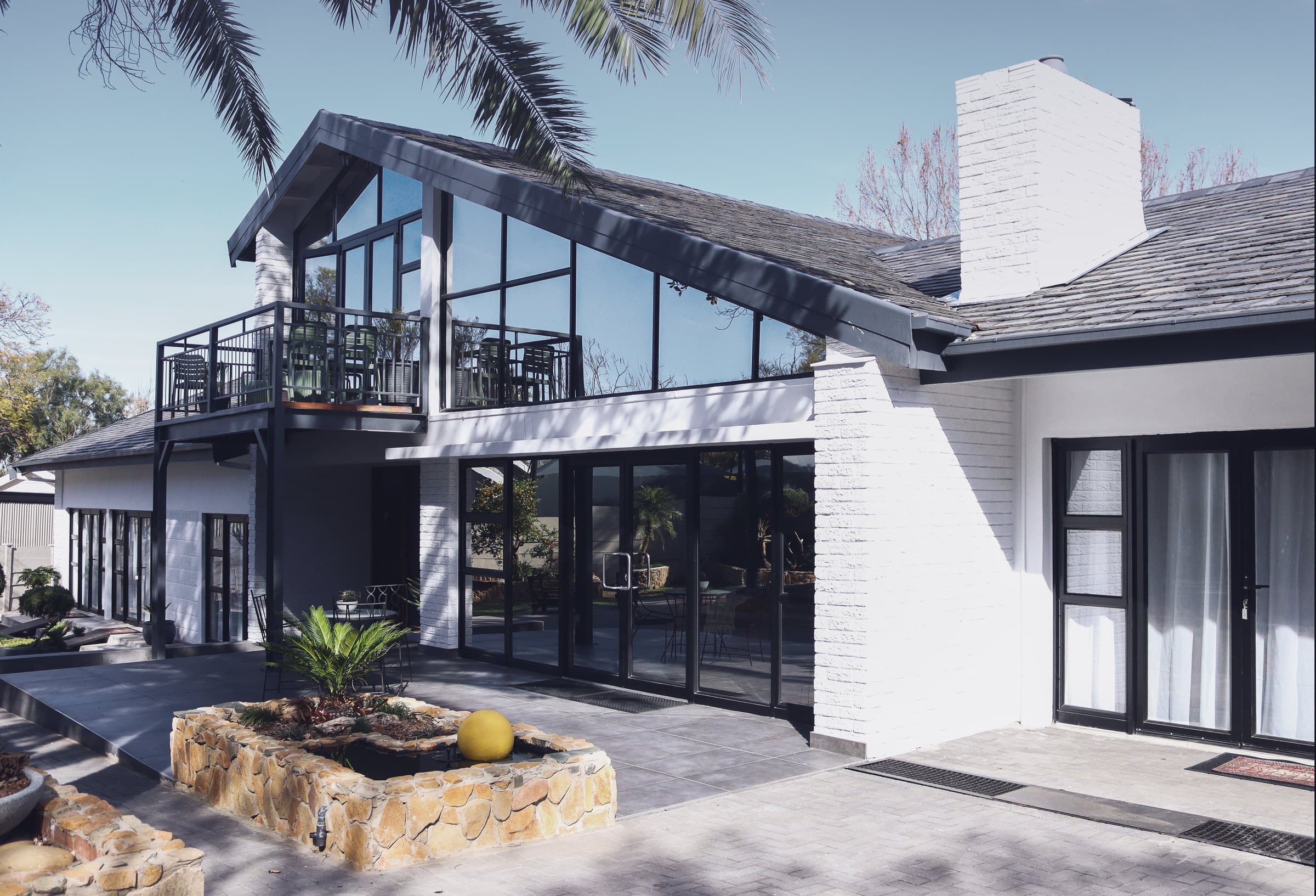 Asania Guest House S: glass-fronted gable, balcony and courtyard
