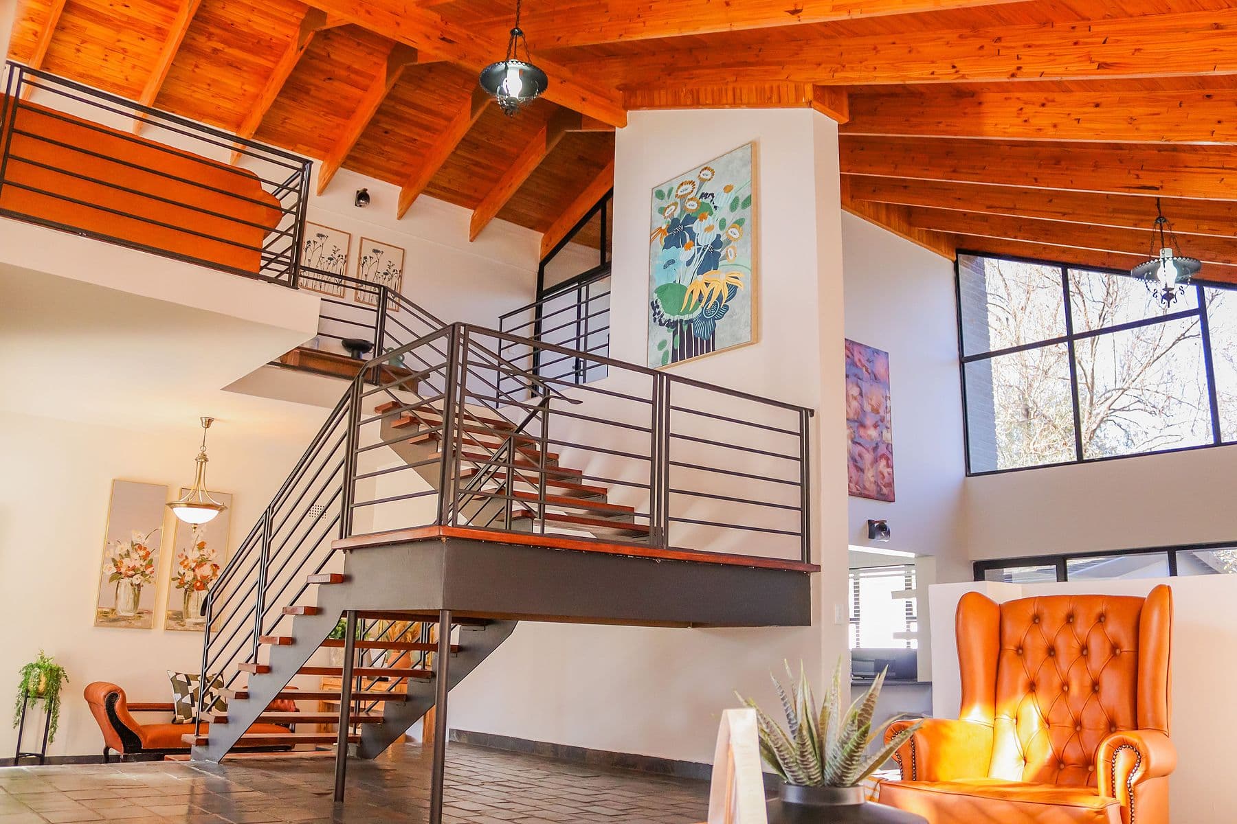 Double-volume lounge with steel staircase